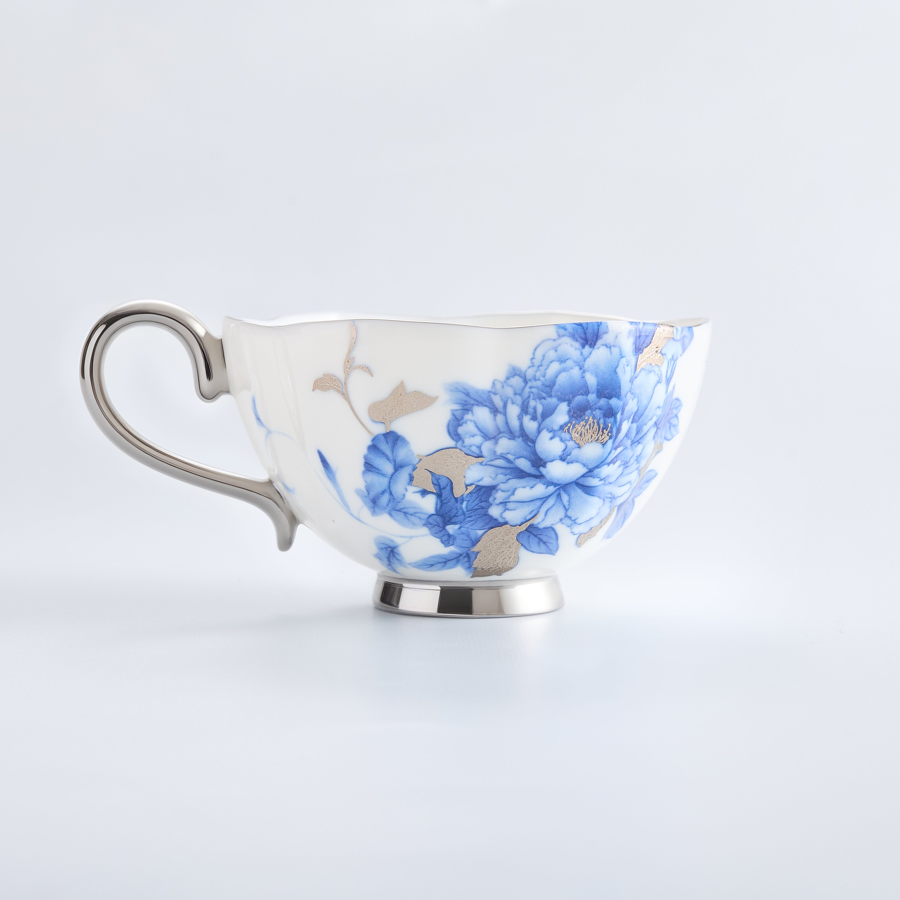 Teacup with blue floral design on a white background