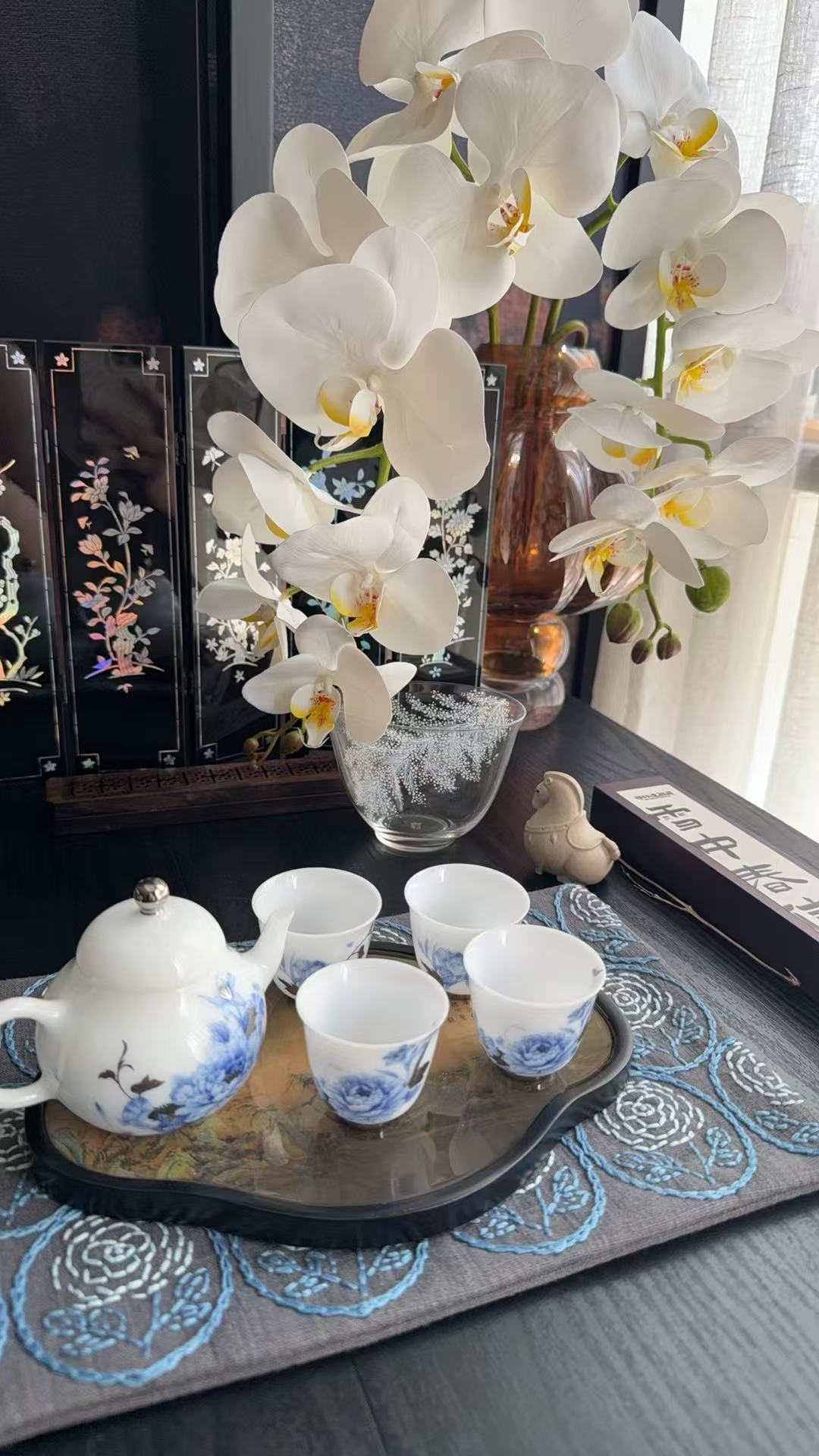 Tea set with white orchids on a table