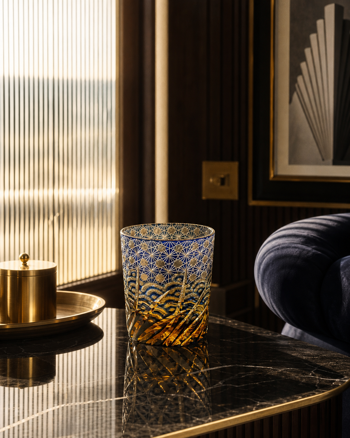 Decorative glass candle holder on a dark surface with a blurred background