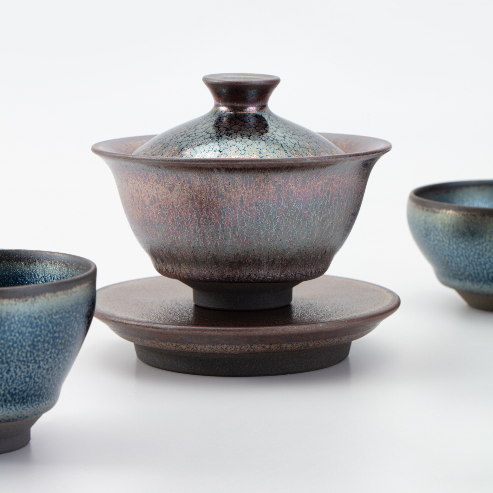 Ceramic teacup set with a lid on a white background
