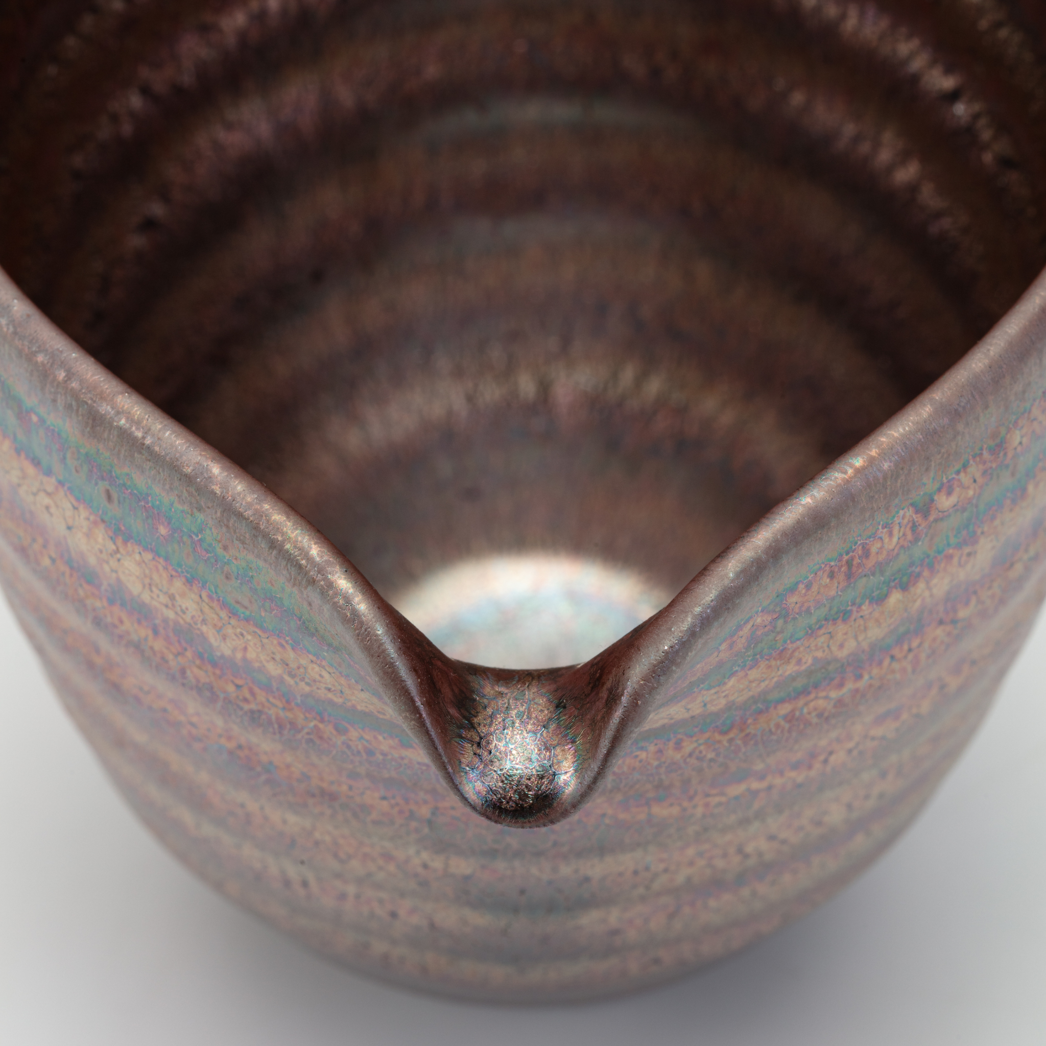Close-up of a ceramic bowl with a textured surface on a white background