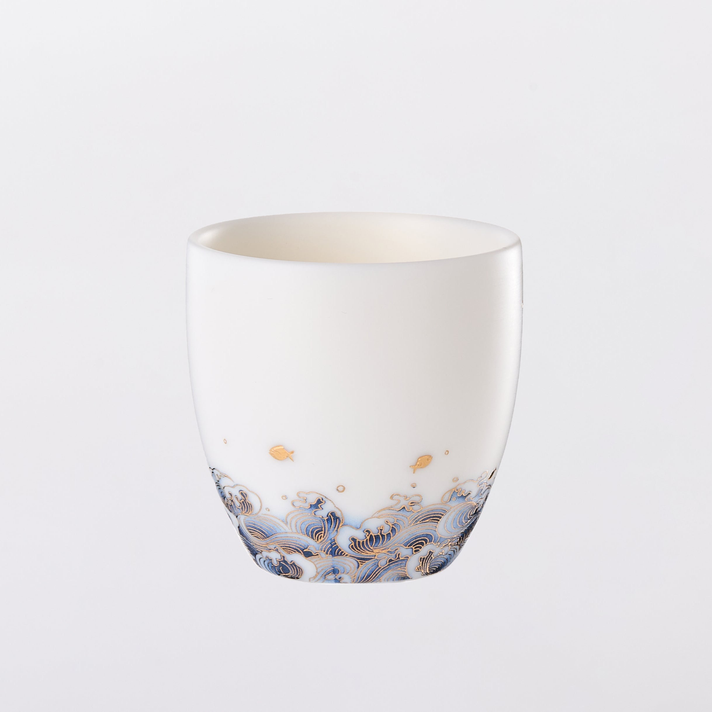 White ceramic cup with multicolored speckles on a light gray background