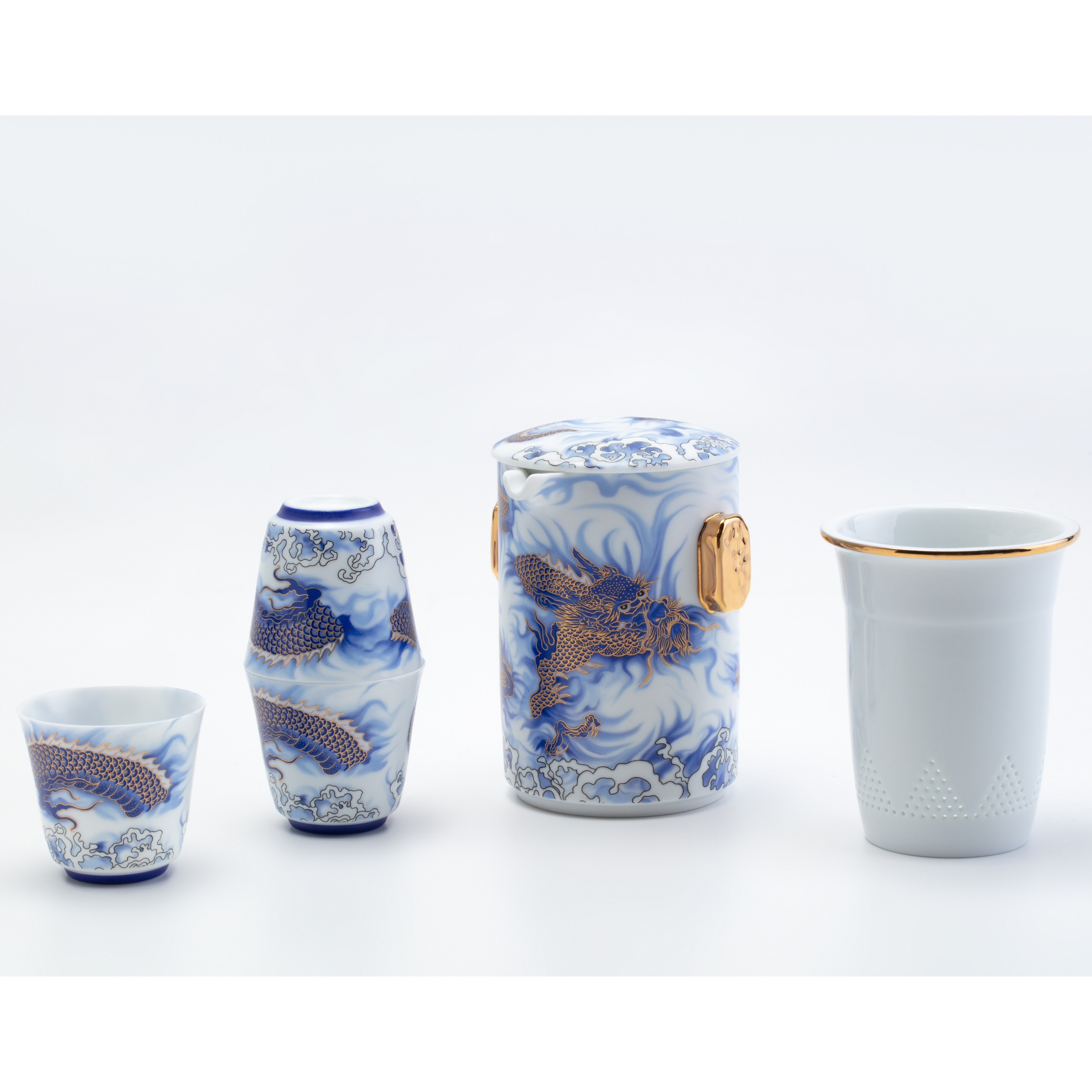 Set of ceramic tea cups with blue dragon design on a white background