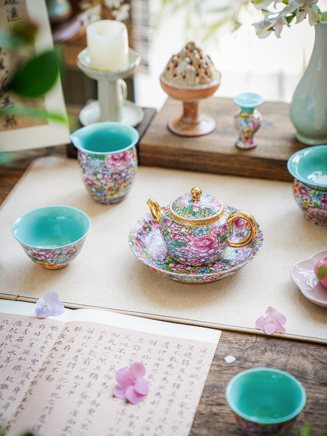 Decorative tea set with floral patterns on a wooden table.
