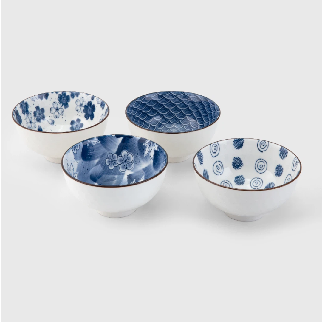 Set of four ceramic bowls with blue patterns on a white background