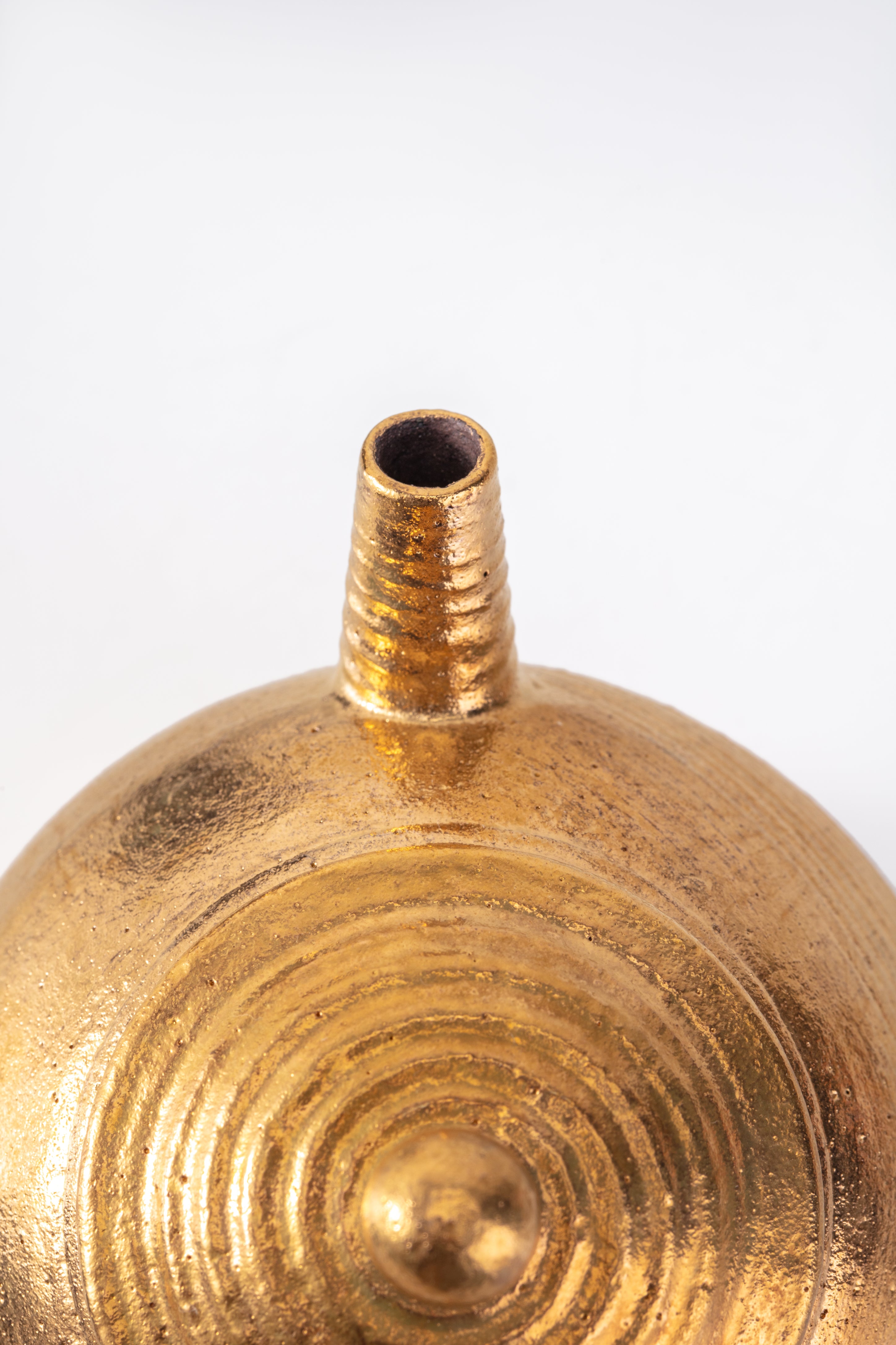 Close-up of a gold-colored decorative object with a white background