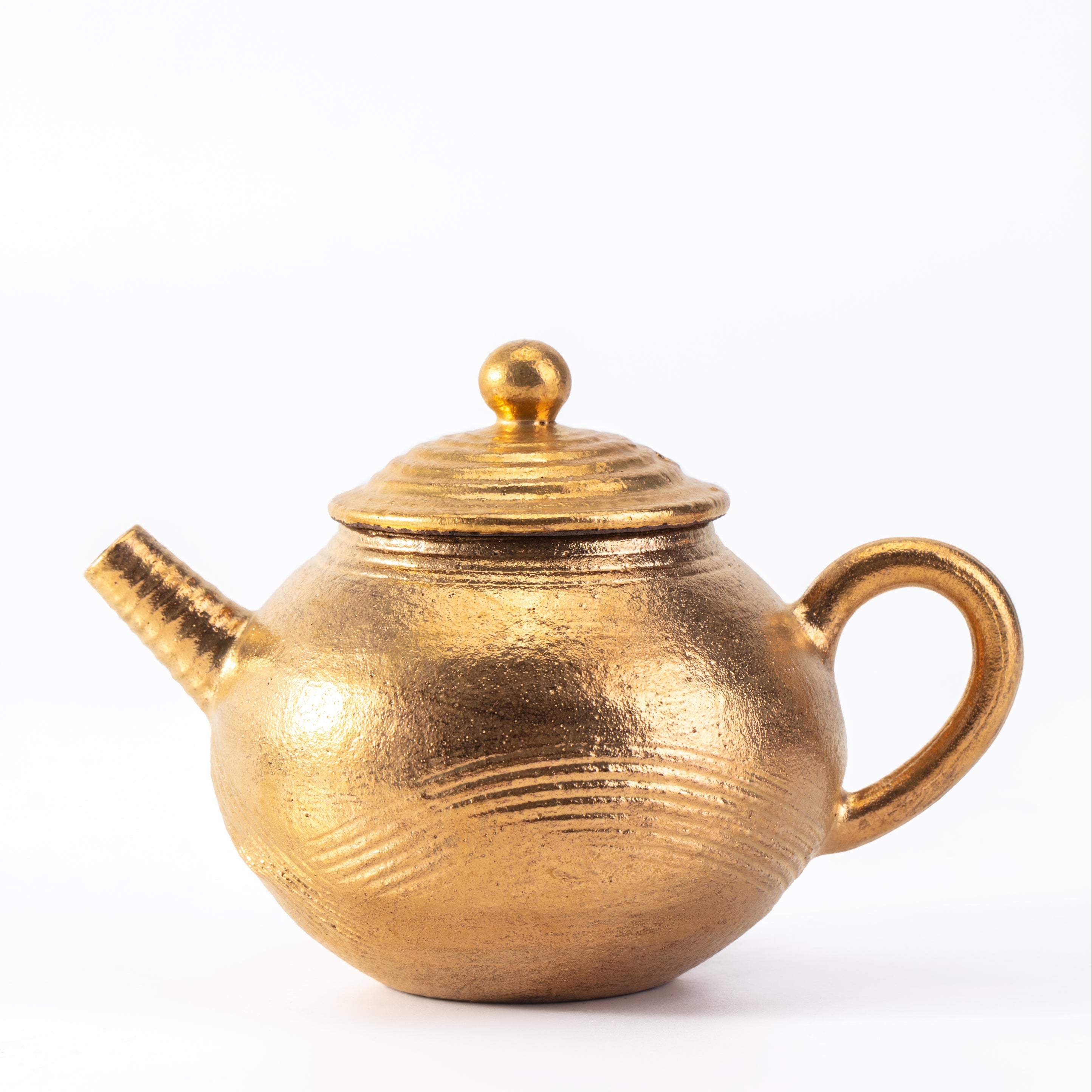 Gold teapot on a white background