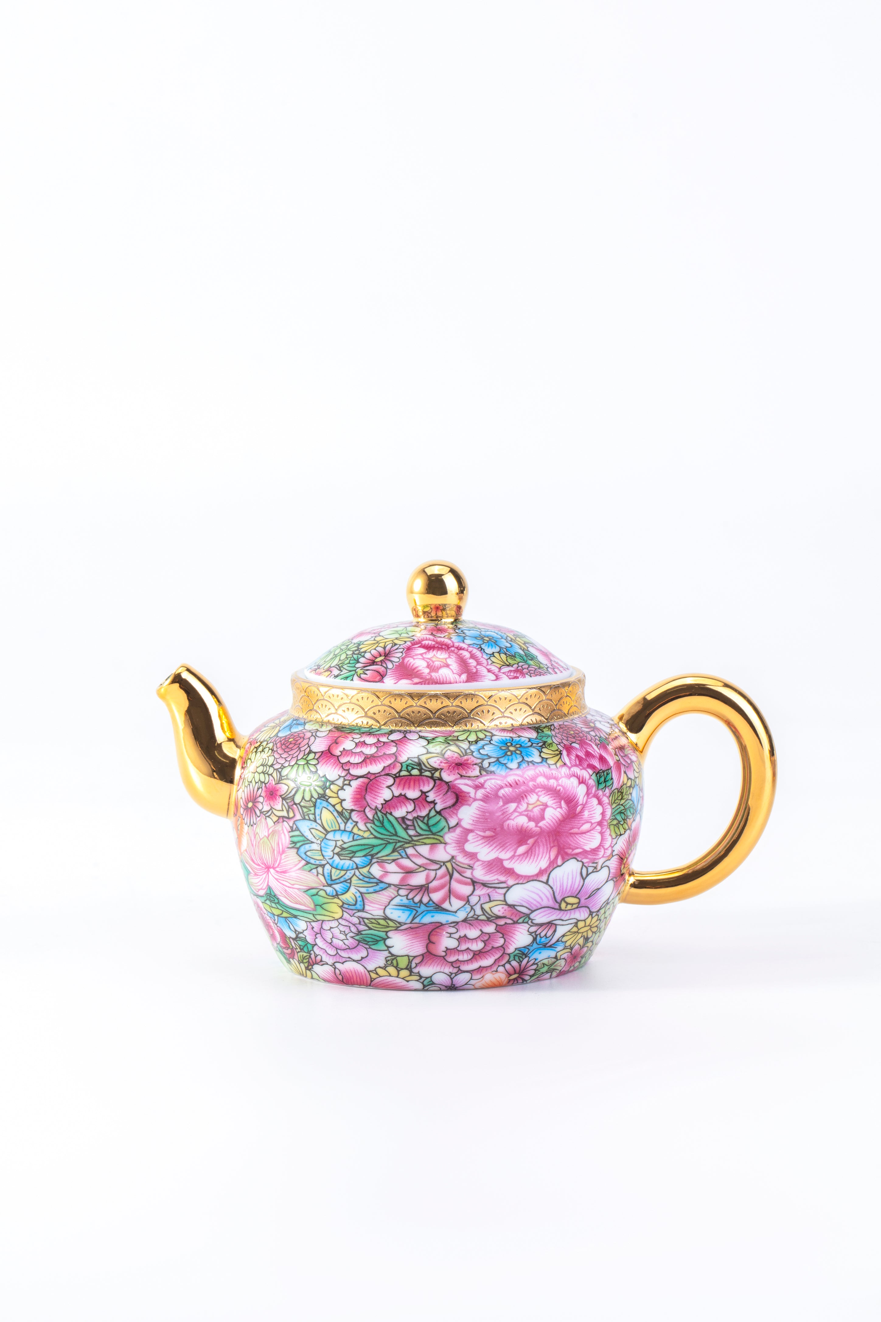 Teapot with floral design and gold accents on a white background