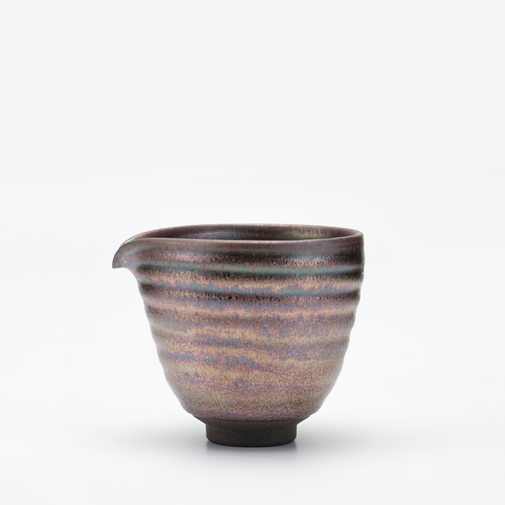 Ceramic cup with striped design on a white background