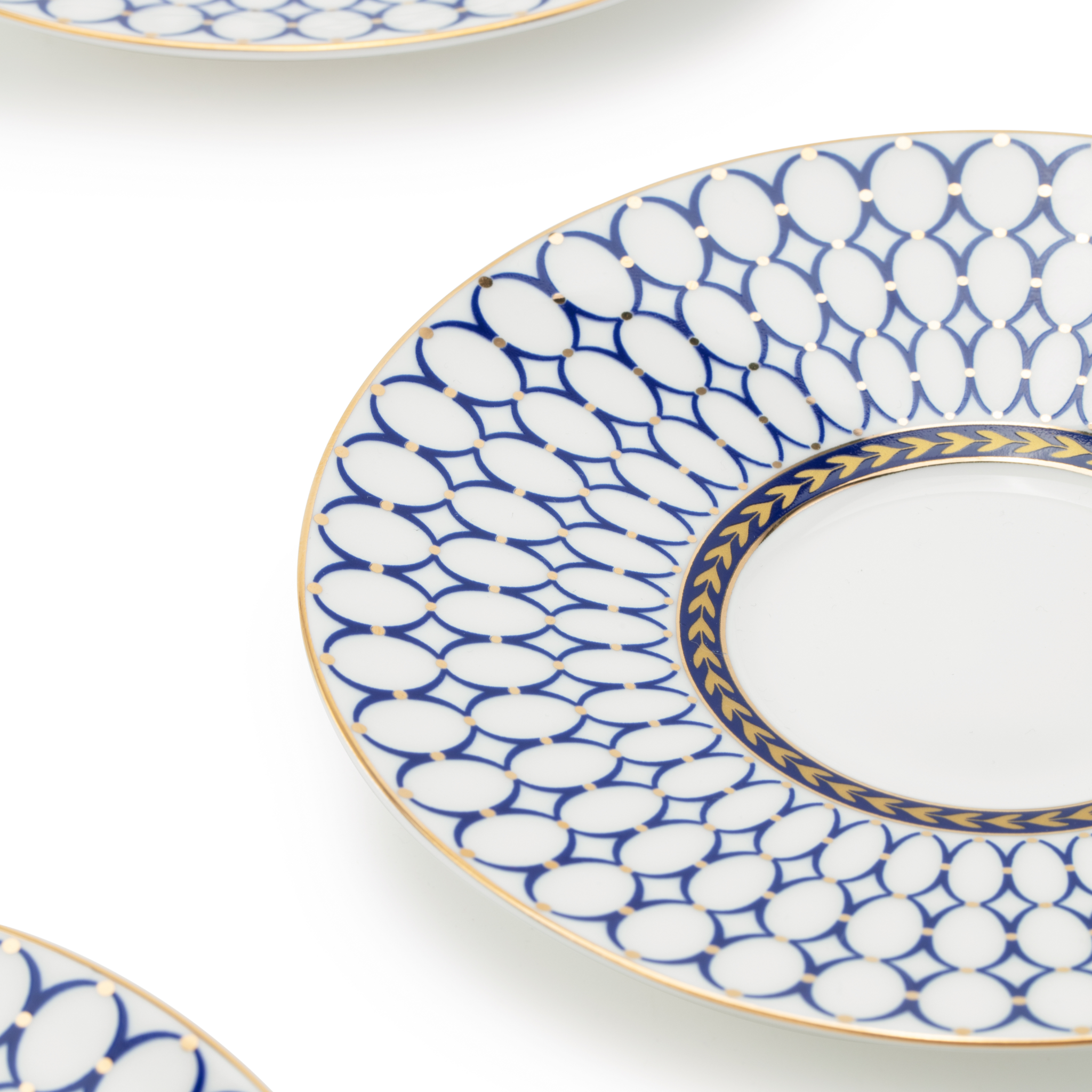 Set of three decorative plates with blue and white patterns on a white background