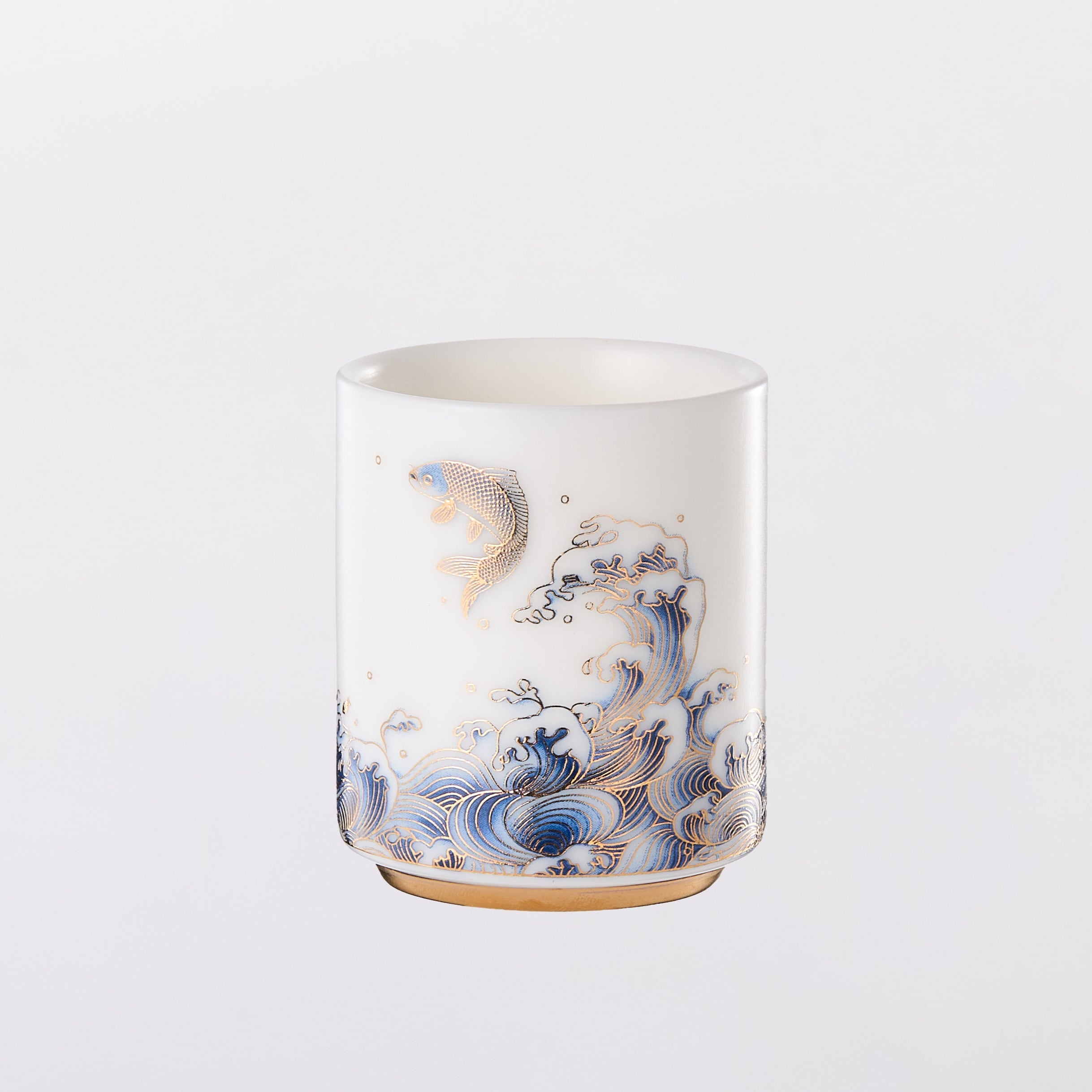 Ceramic tumbler with decorative design on a white background