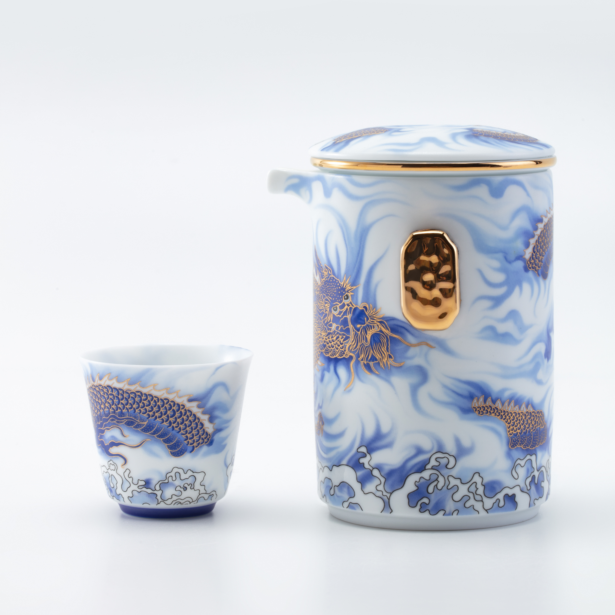 Ceramic teapot and cup with blue and white floral design on a white background